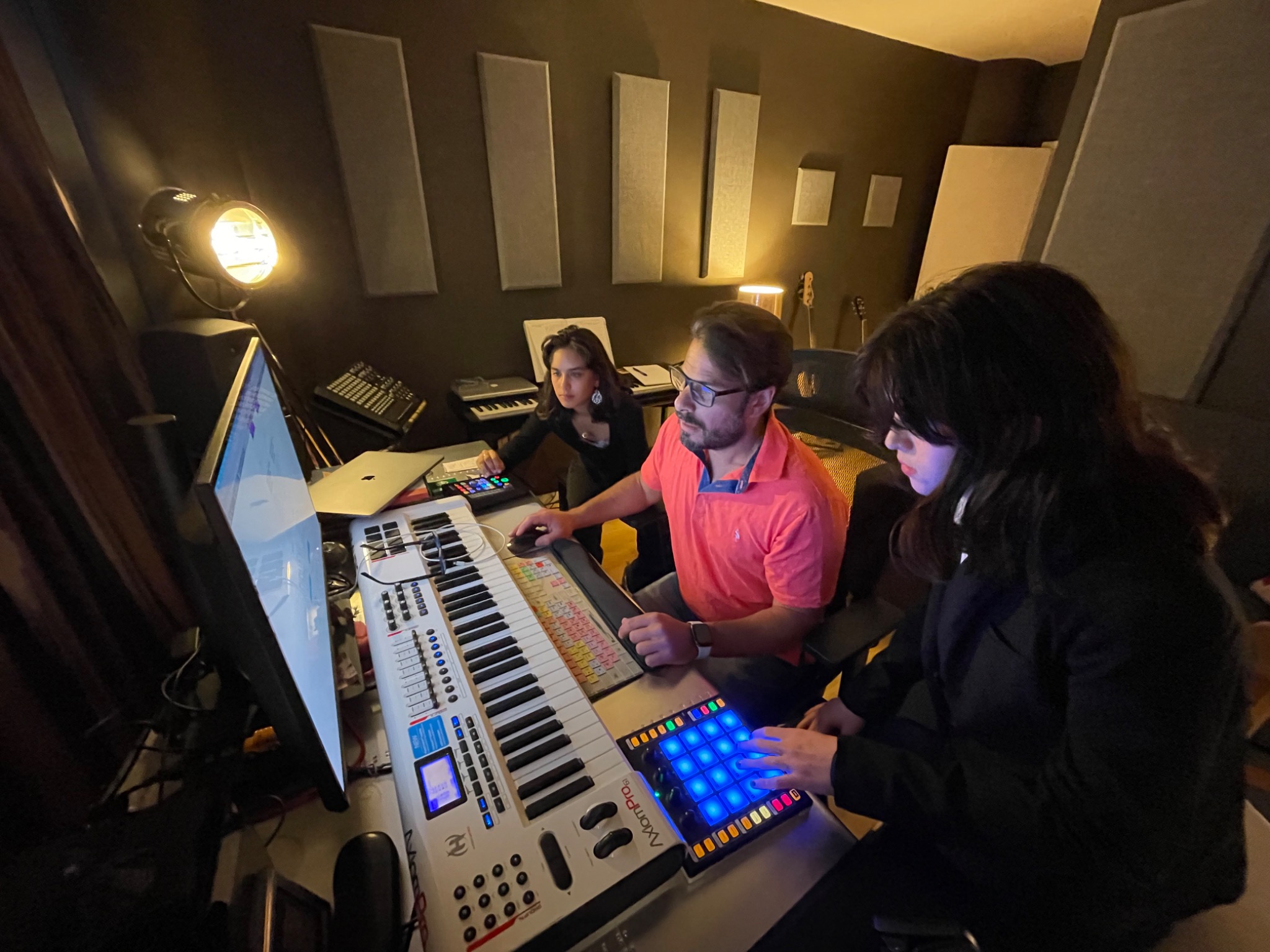 Mr. Djuric teaching two students music production in his Miami studio