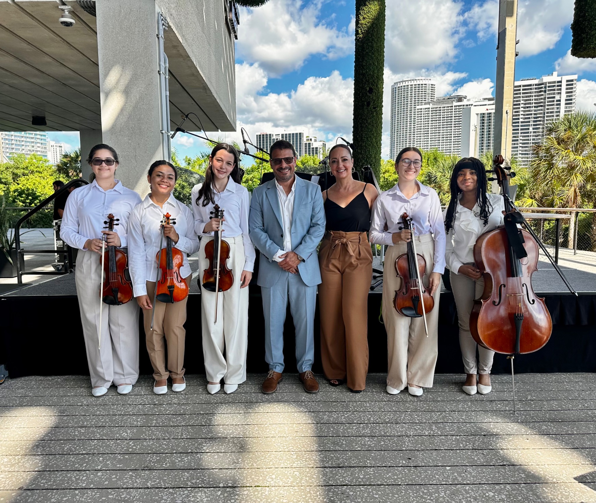Mr. Djuric with a young string ensemble after an outdoor performance in Miami